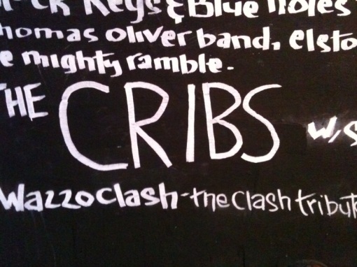Name of the band 'The Cribs' on chalk board