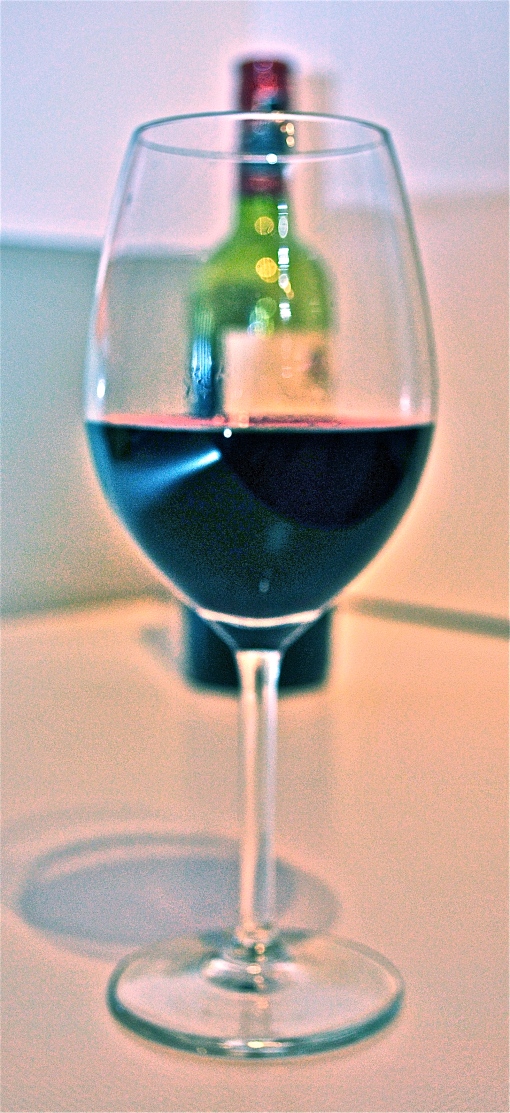 bottle and foregrounded glass of wine